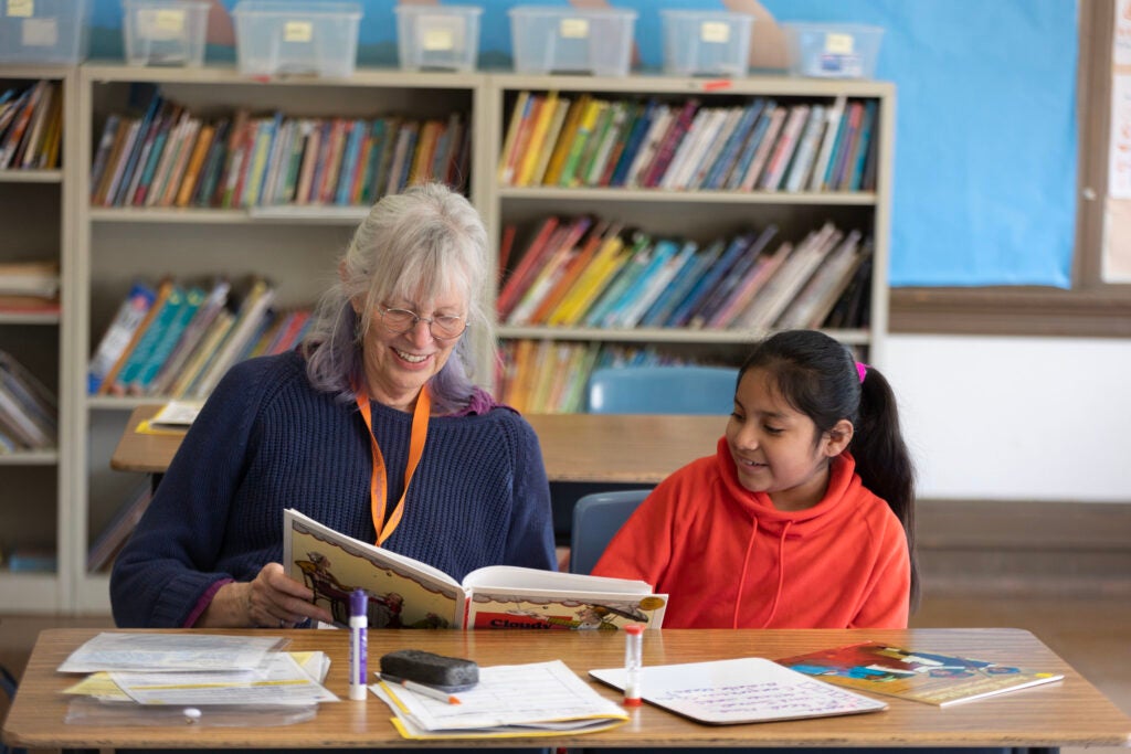 Tutor and student working on reading.