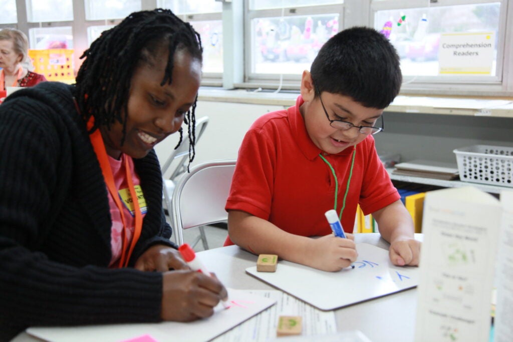 Tutor and student working on writing.