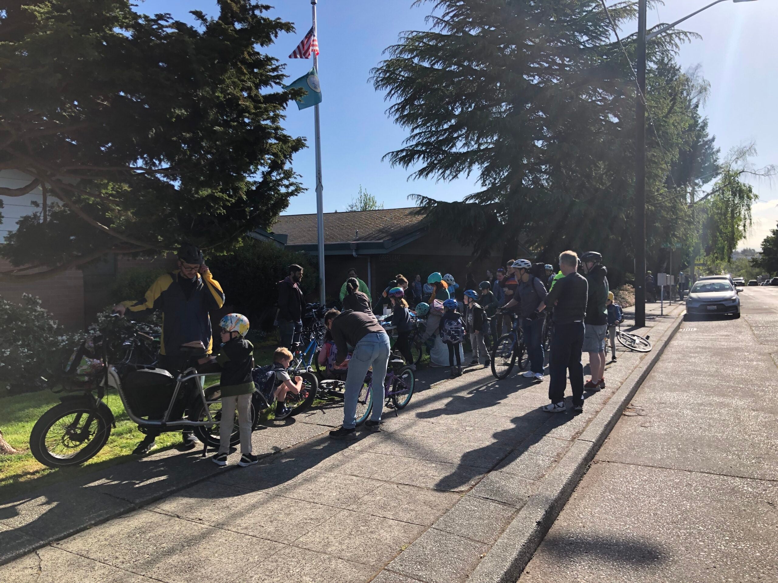 Group of students and caregivers on bikes outside of Green Lake Elementary