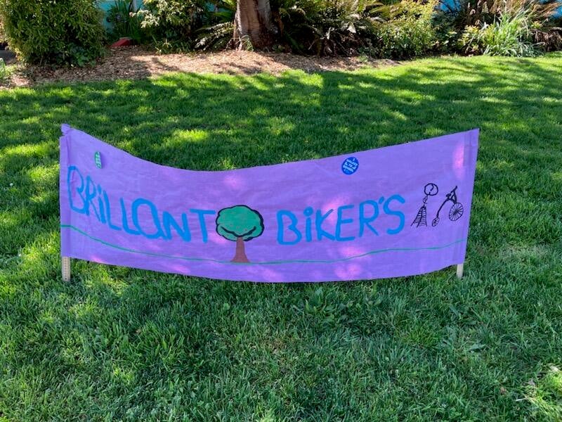 Sign on grass says "Brilliant Bikers"
