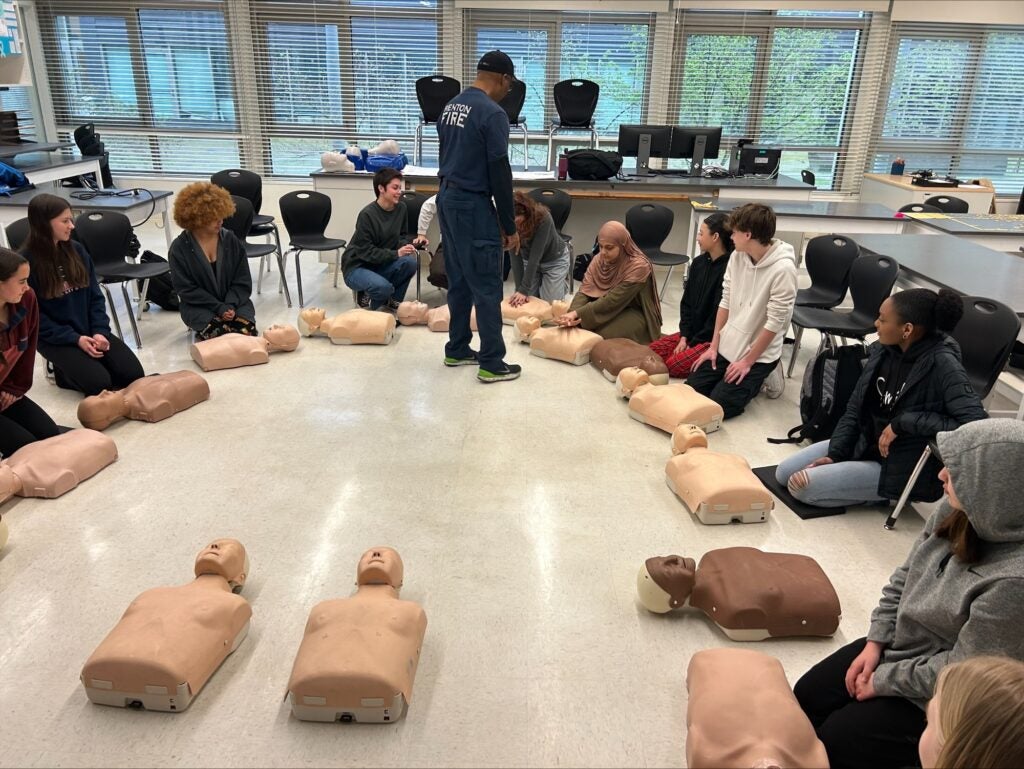 Students training CPR