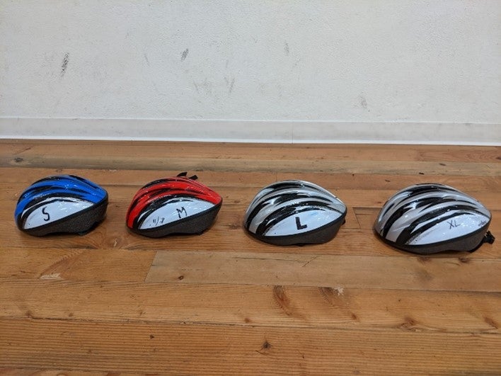 Helmets arranged by color and size.