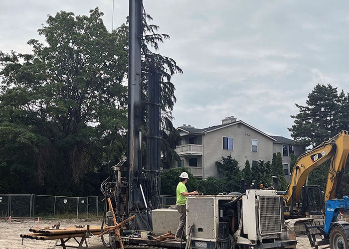 a drill rig with a person operating it