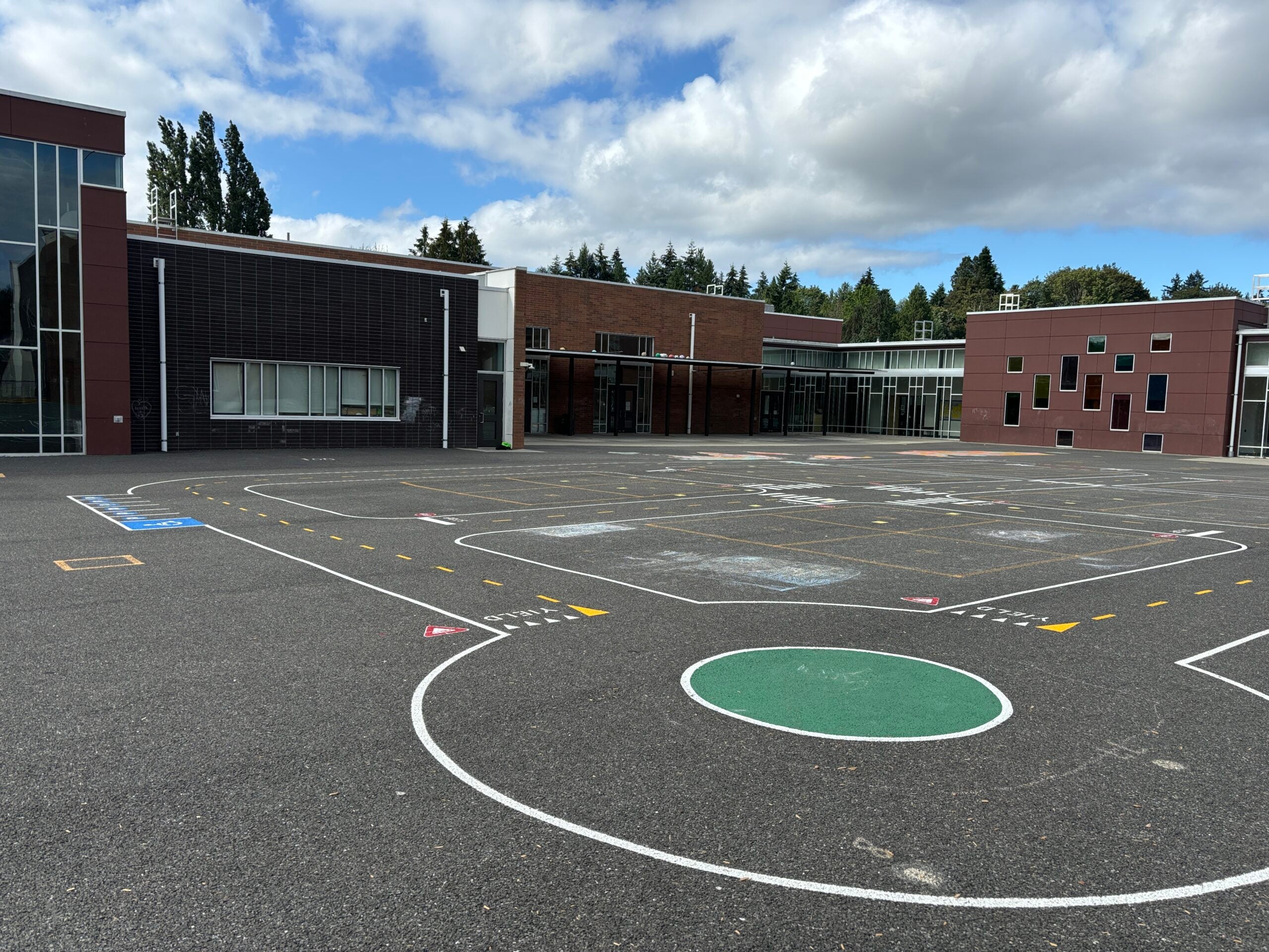 Miniature road with roundabout painted on blacktop.