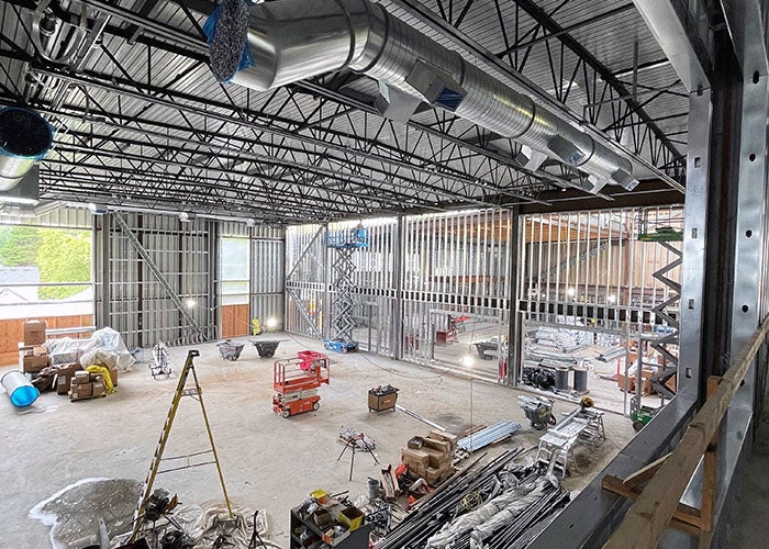 a building under construction with materials on the floor and high ceiling