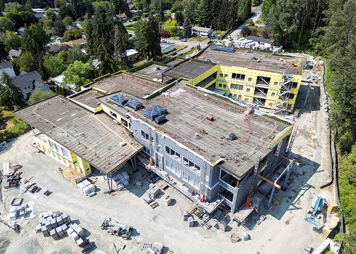 a building under construction with a lot of construction equipment and materials