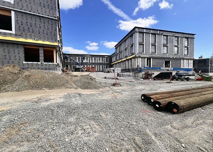 a building under construction with gray material on the exterior walls