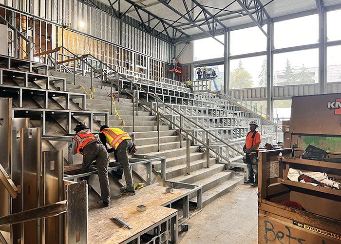 people are working on deep stairs in a room under construction