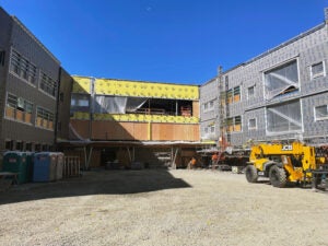 a courtyard space between two wings of a building under construction