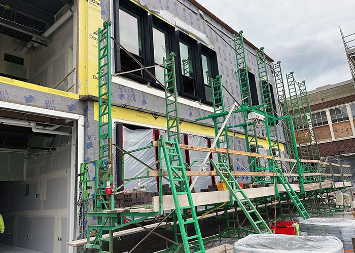 part of a new building under construction with scaffolding