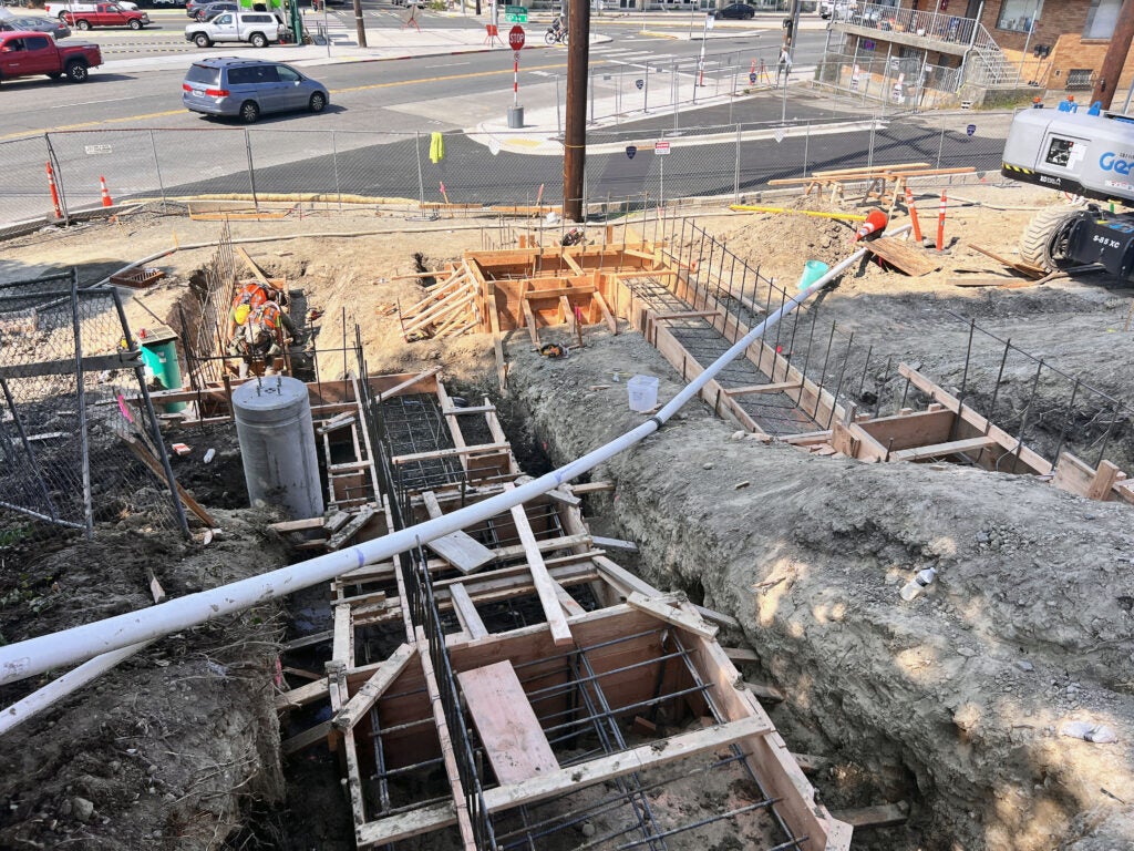 looking down a hill that has wood forms with rebar ready for concrete