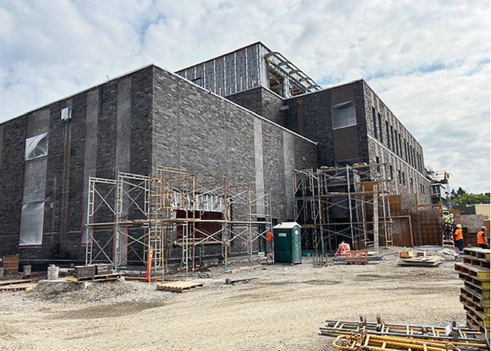 outside of a brick building under construction with scaffolding