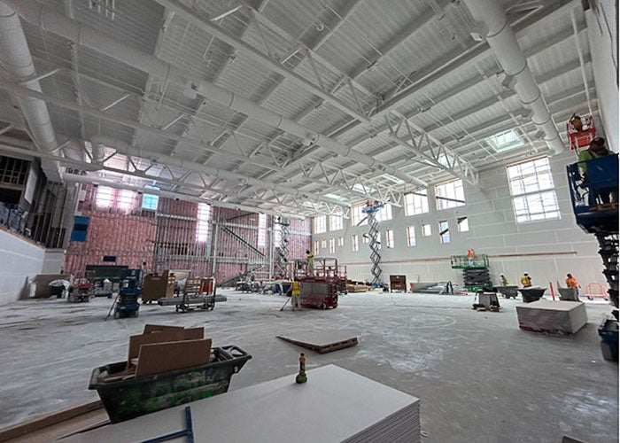 inside of a large room under construction with construction materials and equipment