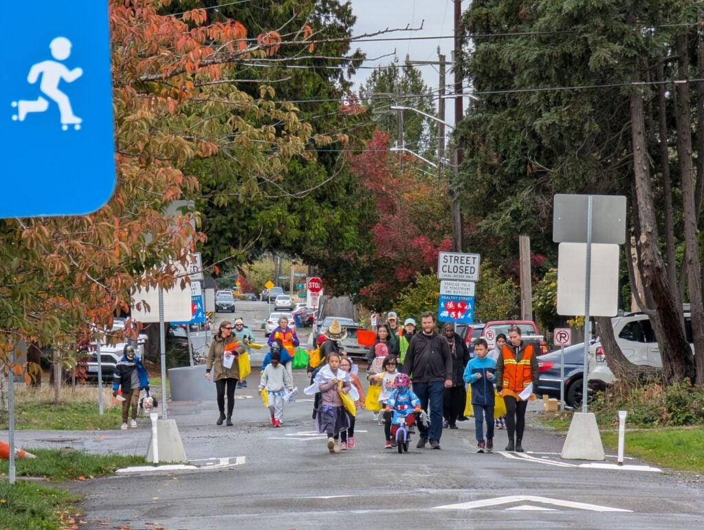 Students and families walk to school on "Stay Healthy" street.