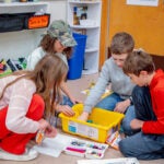 Students at Lafayette Elementary School prepare for the robotics competition by building sets and coding robots.