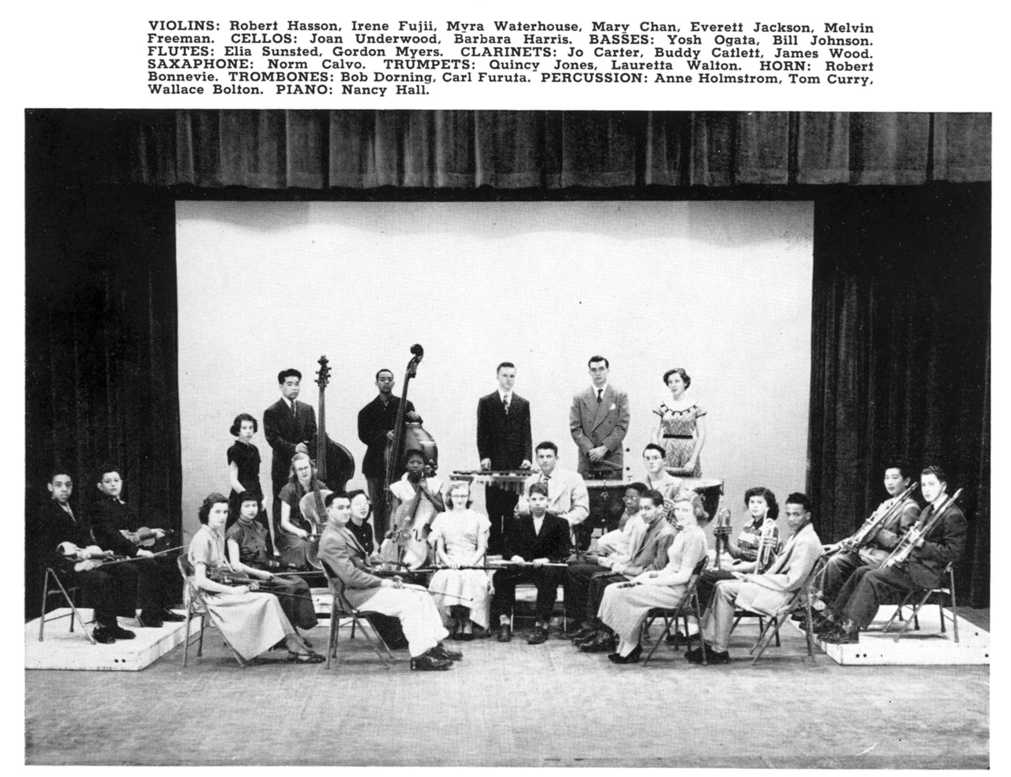 Quincy Jones sits with trumpet along with other students with instruments in the orchestra