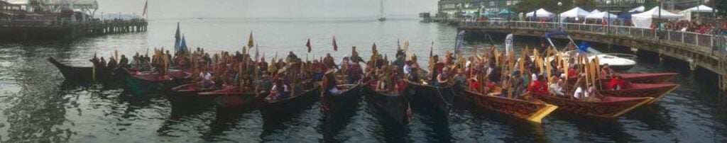 Salmon Homecoming boats lined up at the shore in downtown Seattle