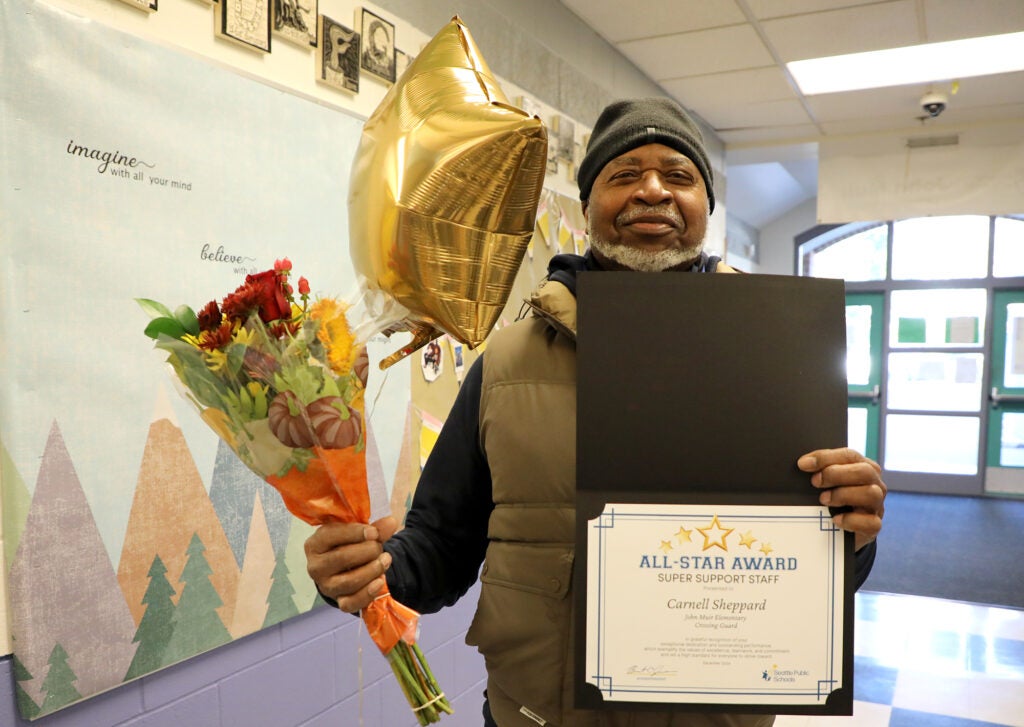 Crossing guard Carnell Sheppard with his All-Star Award at John Muir Elementary