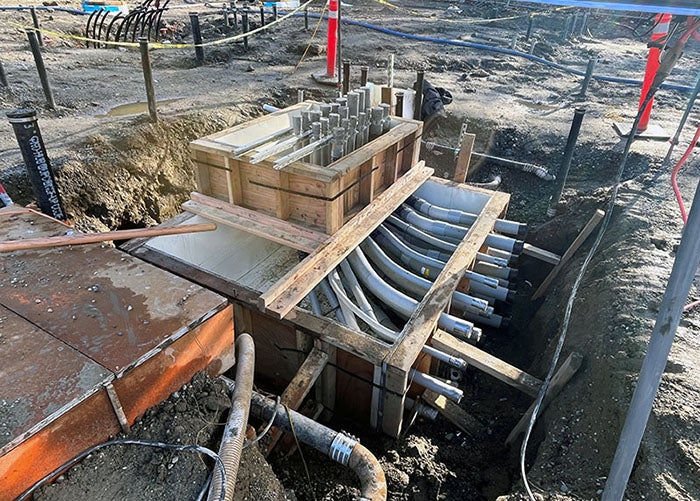 a box with pipes in a hole in the ground