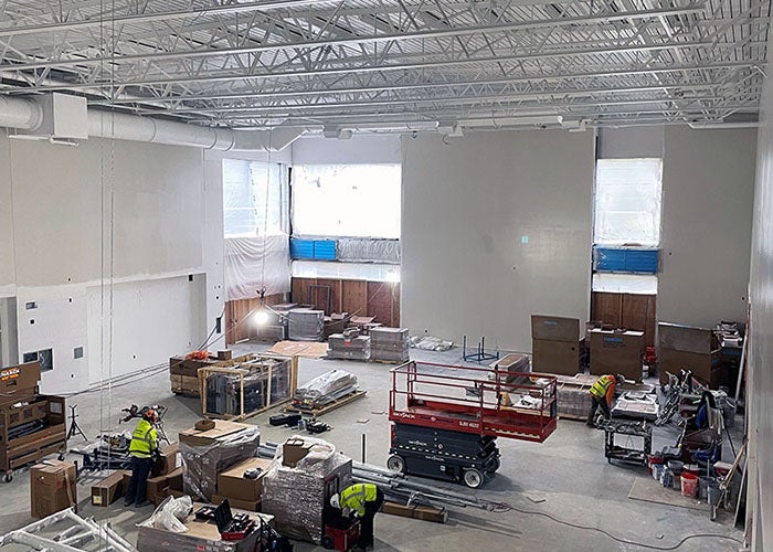 a large room with high ceilings has equipment for construction