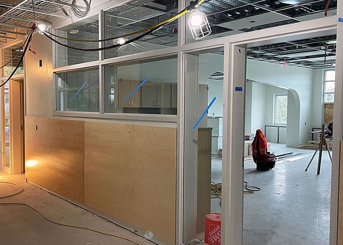 part of a hallway with a window and door leading into a classroom space