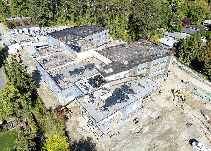 aerial of a building under construction with site equipment