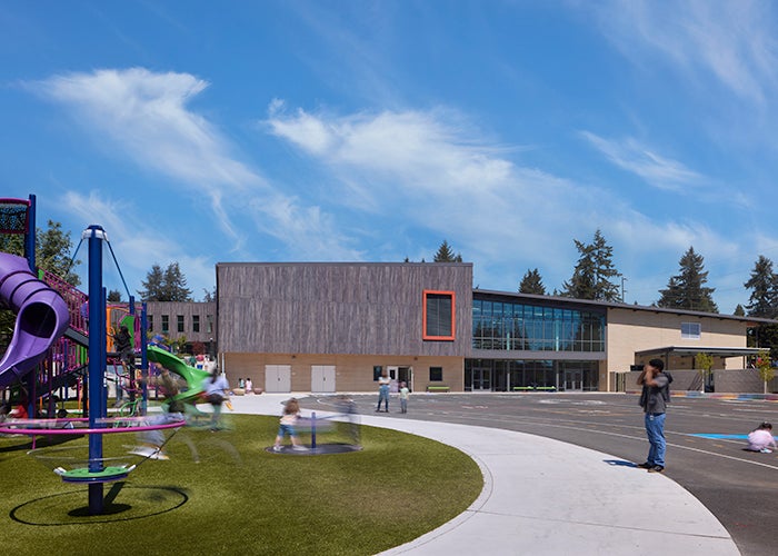 a playground with a building in the background