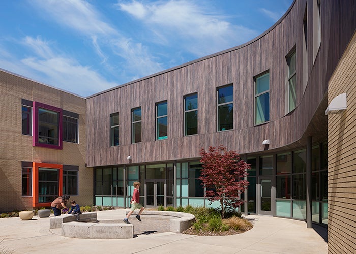 a courtyard area with a building curved around it