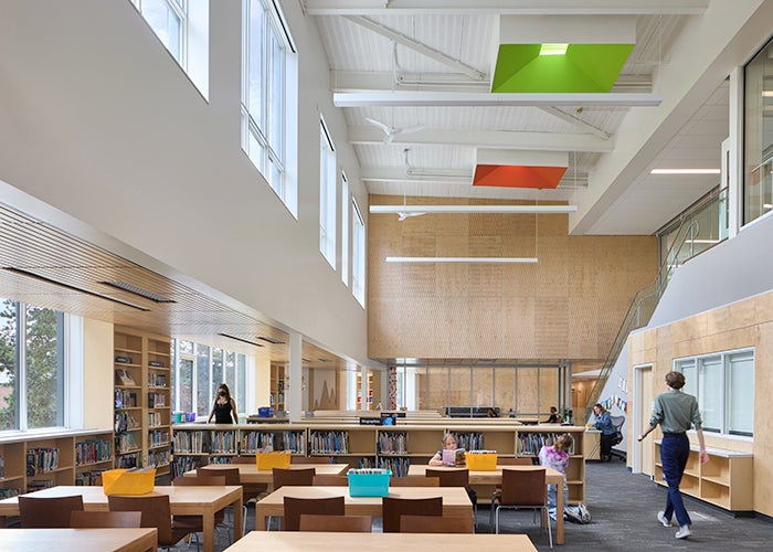 a library with high ceiling and windows