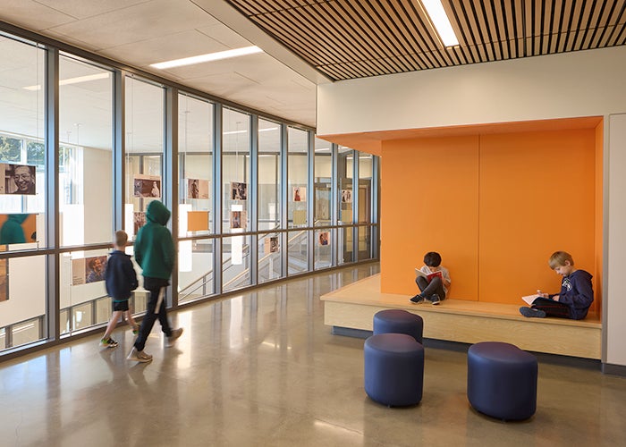 an orange nook and seating with a window area