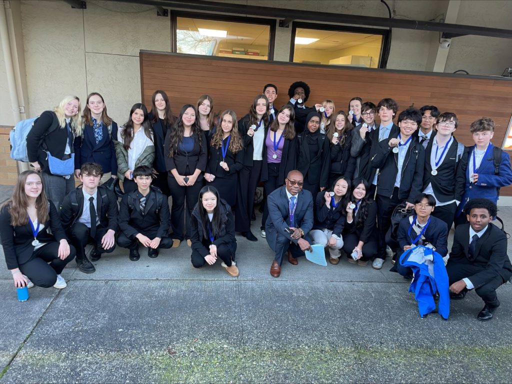 group of students holding medals at competition