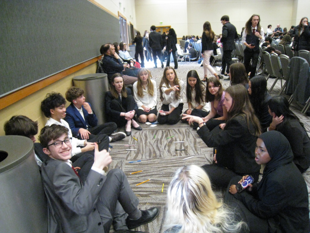 students brainstorming in hallway at competition