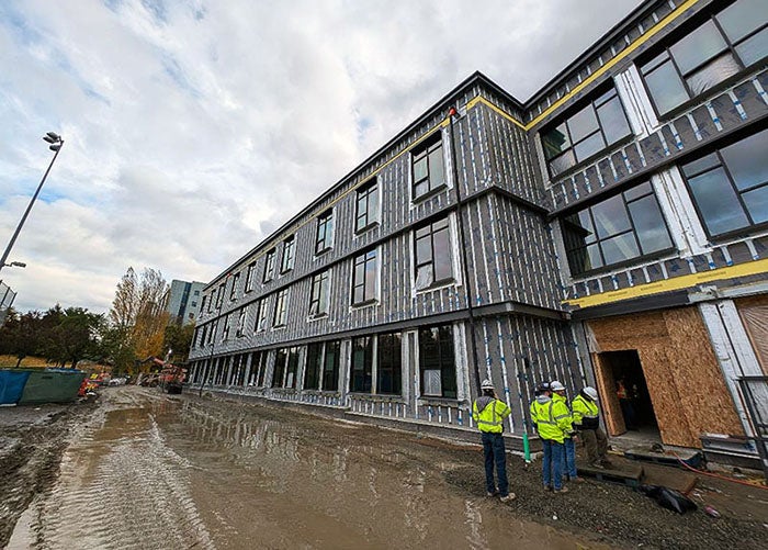 building under construction with three floors of windows