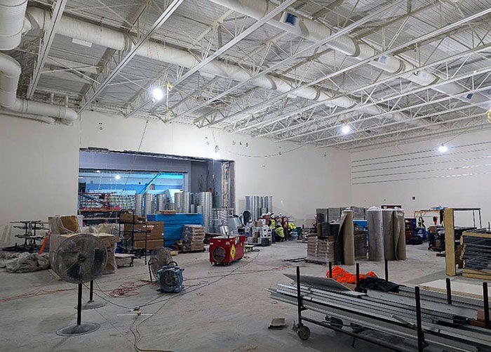 lifts are being used to put in ductwork in a large room