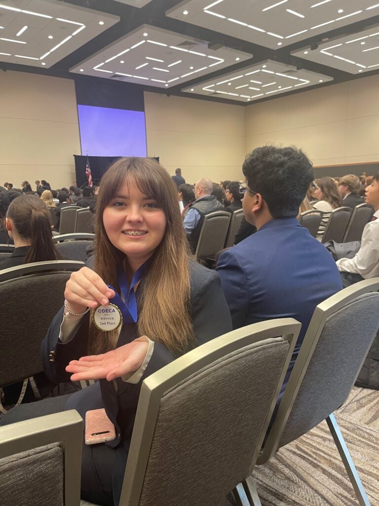 Student holding medal