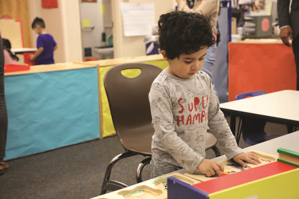 Preschool student doing a math activity at a table