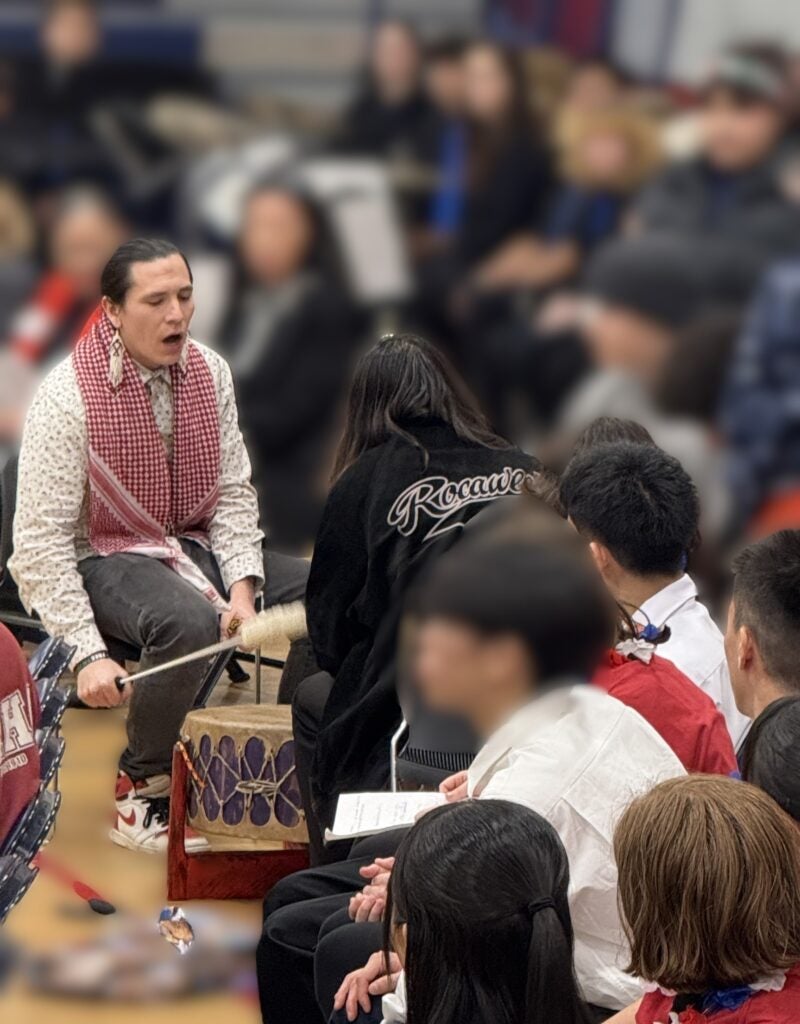 Photo of Native man drumming and singing