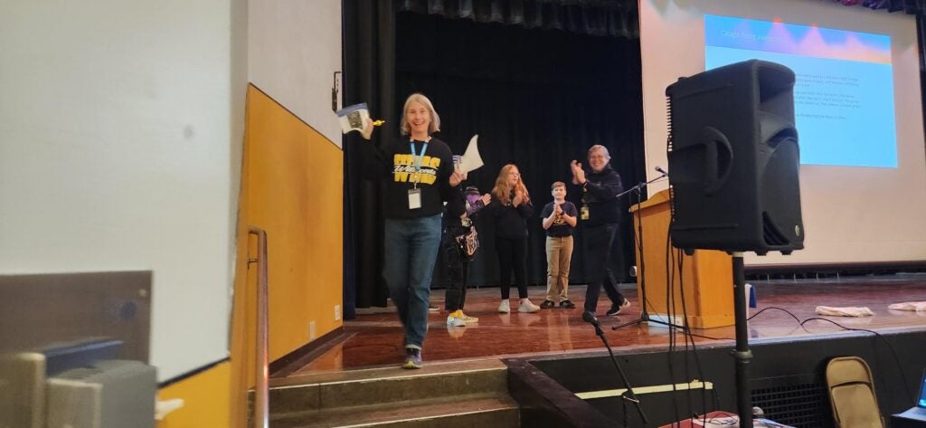 Janice Runner on stage with award.