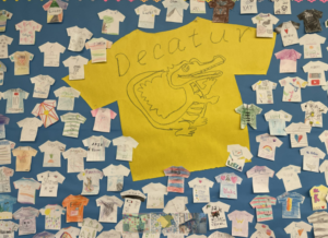 Decatur shirt surrounded by kid drawings