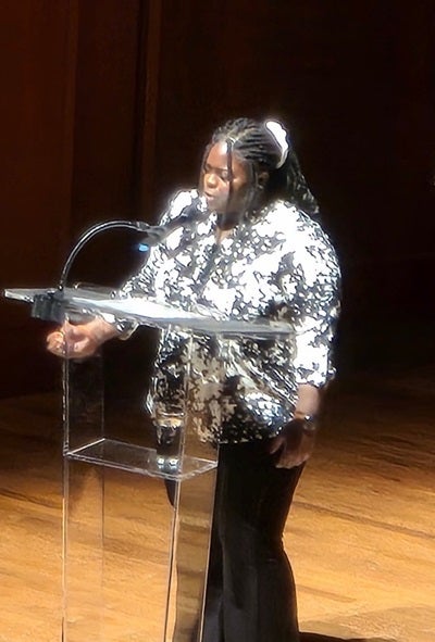 Student Marie A. reading poem at Benaroya Hall to open the night with Supreme Court Justice Ketanji Brown Jackson