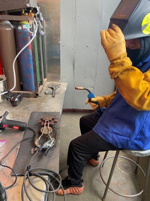 student pausing in welding