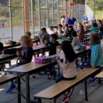 Second-grade students eating lunch outside in our covered play court area on the first day of school (2021-22 school year). Photo by Elise Olson