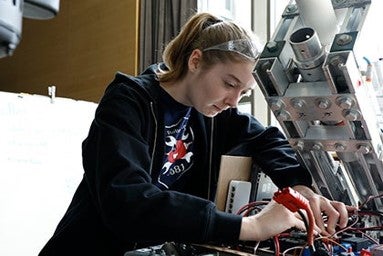 Female student working on a robot