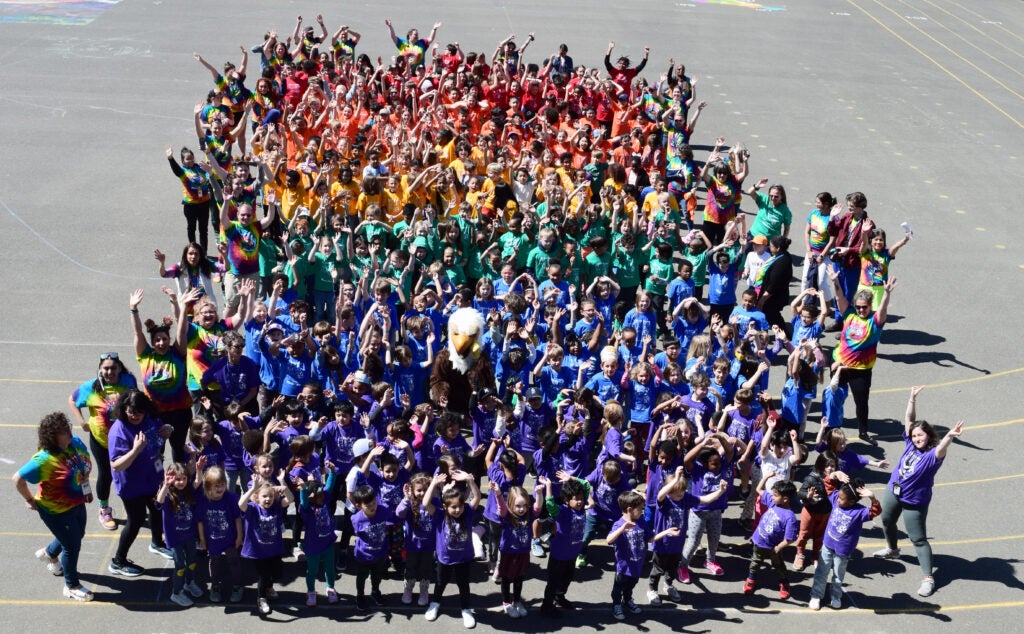 colorful group photograph of students in different colored tshirts