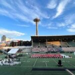 Graduates on field at Memorial Stadium. Photo Credit Rachel Hart Rios