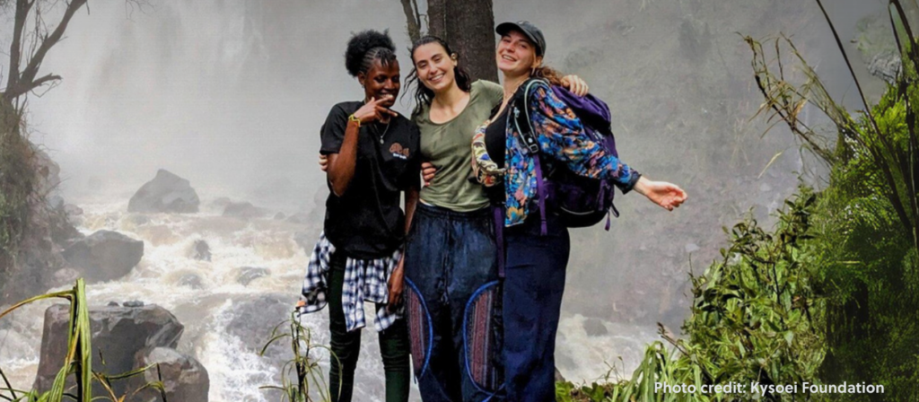 3 students in the woods hiking